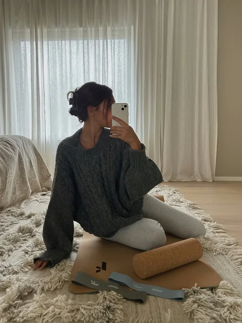 Creator with a yoga mat and training accessories