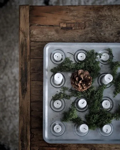 Candles and moss on a metal tray