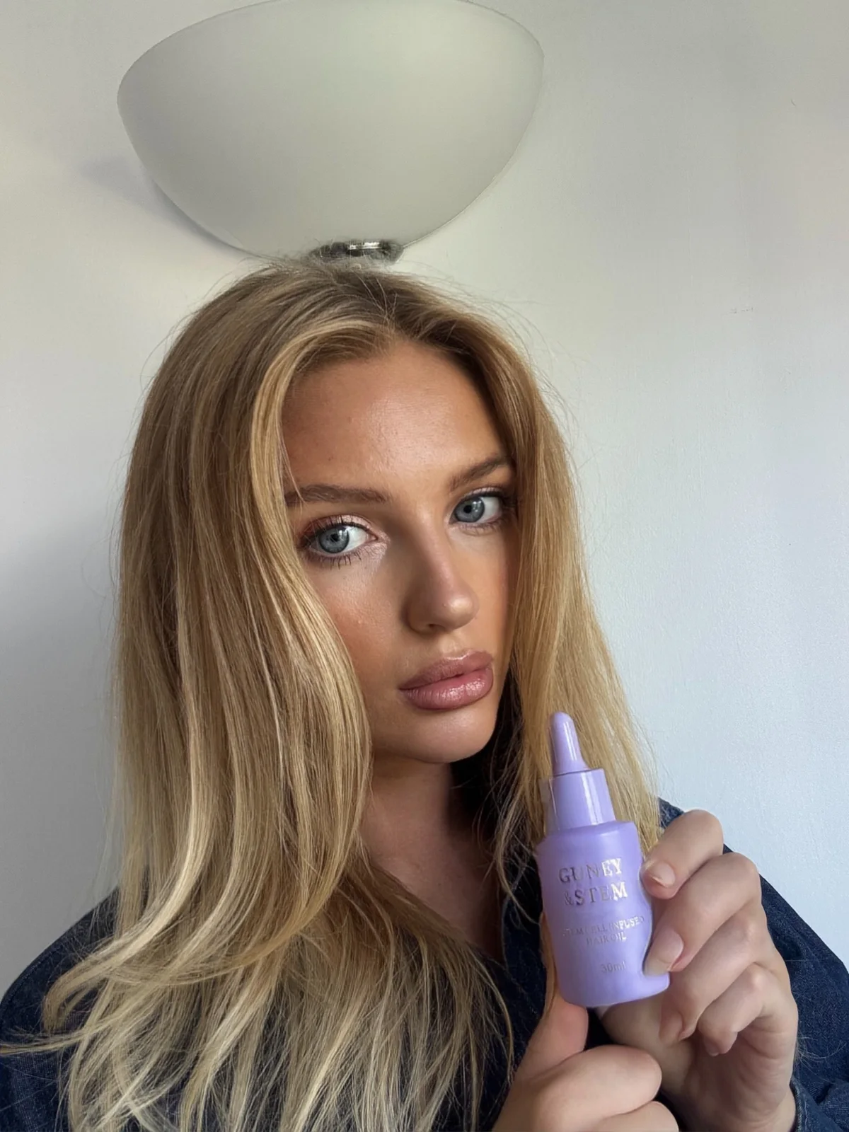 Creator holding the lavender Guney & Stem bottle