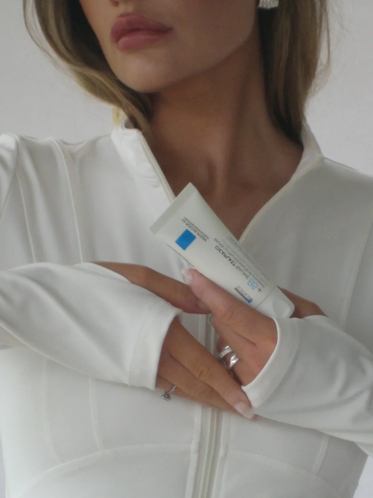 Creator holding a skincare product