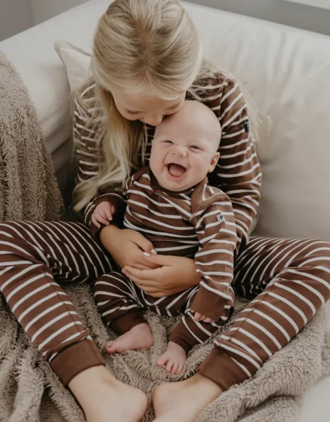 Two children wearing matching striped clothing