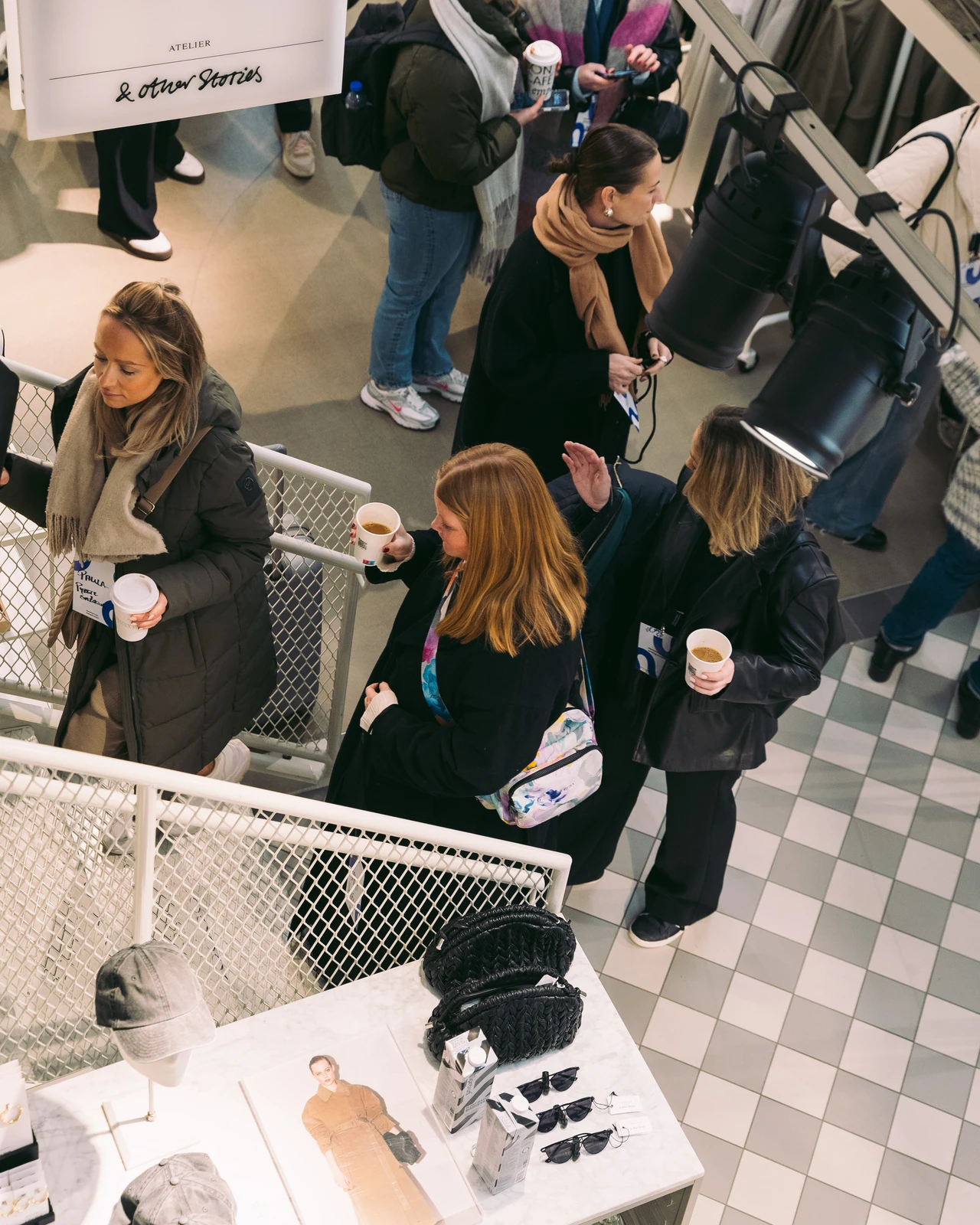 Guests with coffee on the stairs inside & Other Stories.