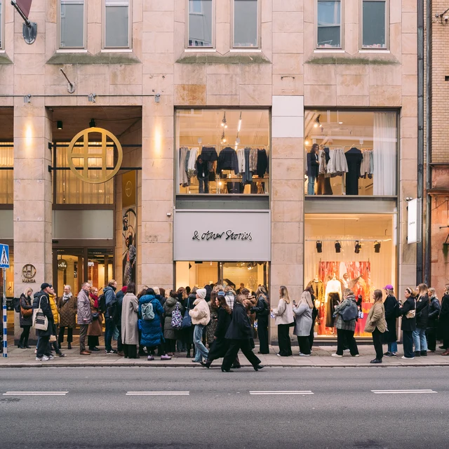 Guests gathering outside the entrance to & Other Stories.