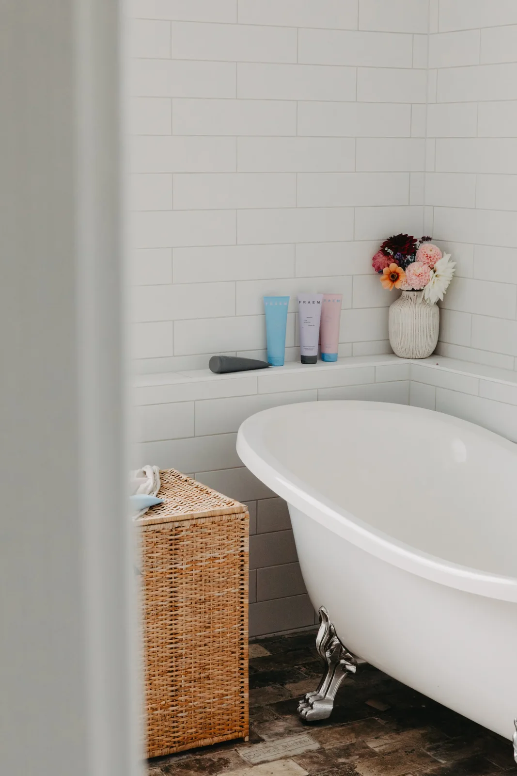 Skincare products beside a bathtub