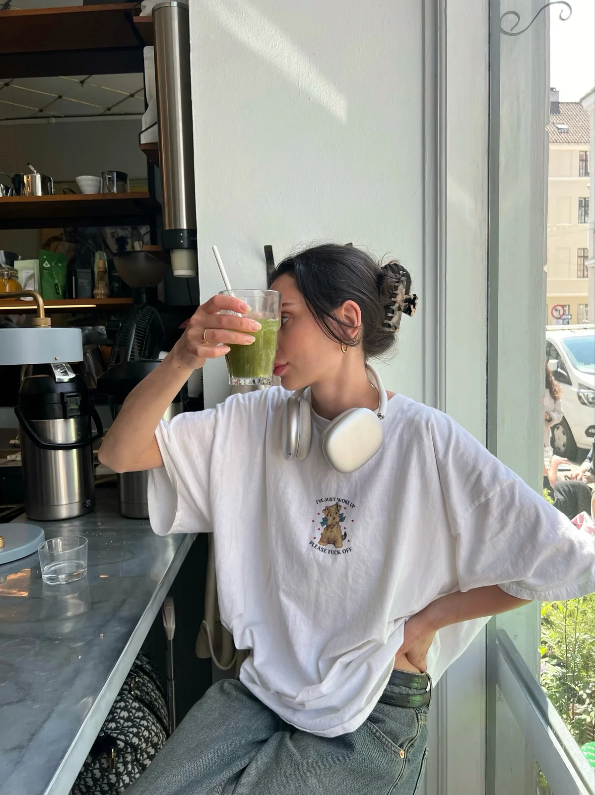 Creator with a green drink at a café