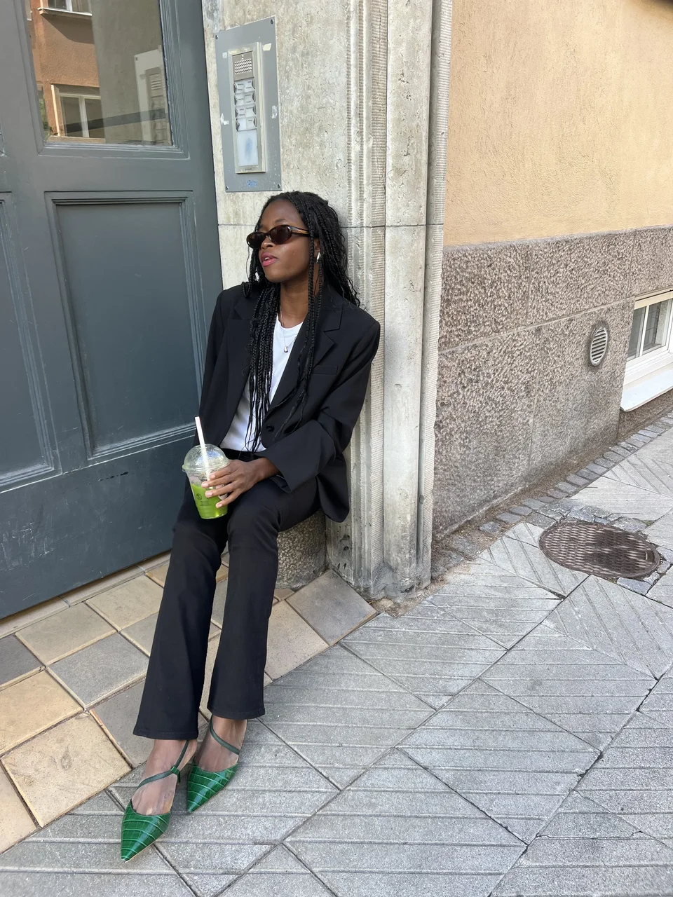 Creator styling a dark suit with green heels