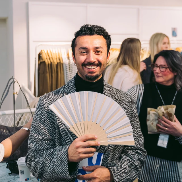 Two guests with folding fans at & Other Stories.