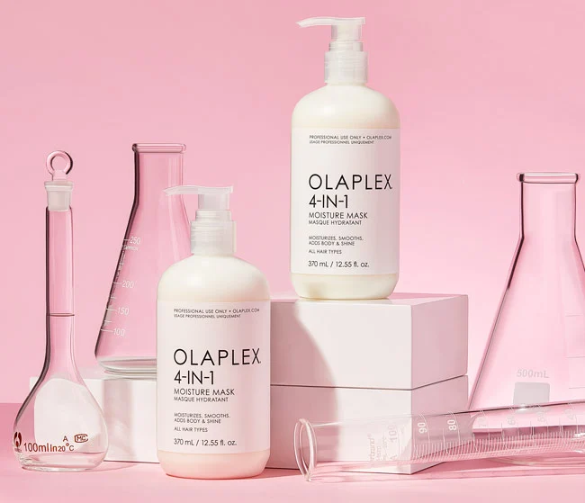 OLAPLEX 4-IN-1 Moisture Mask against a pink background