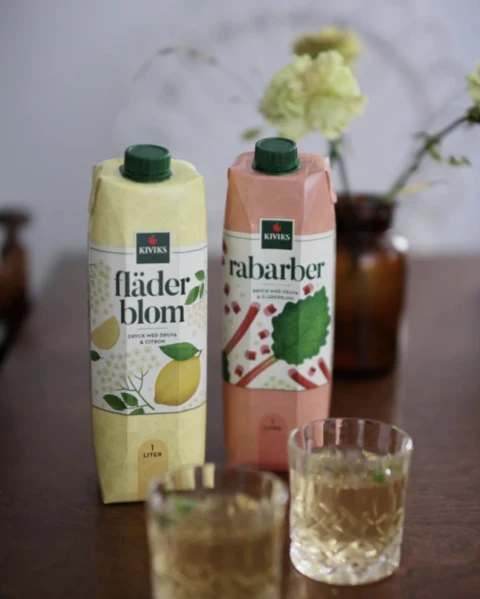 Kiviks elderflower and rhubarb drinks with glasses on a table