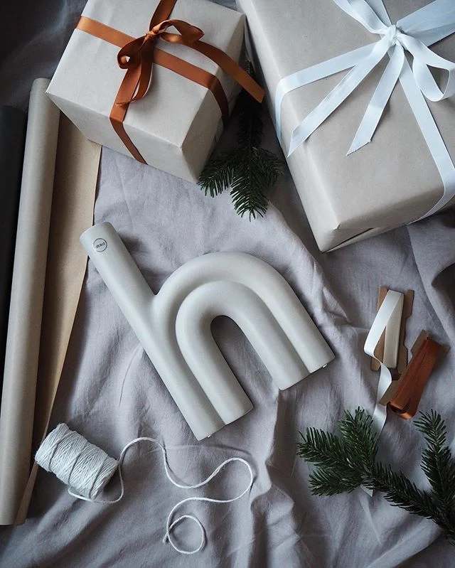 Wrapped gifts and a sculptural candle