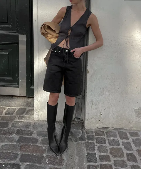 Creator in a dark outfit outdoors
