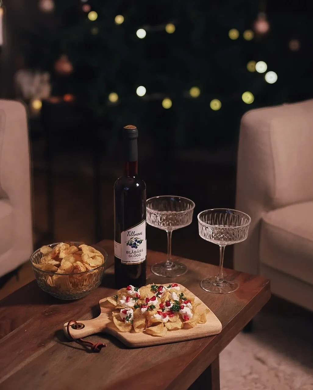Snacks and pizza on a table with candles