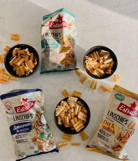 Estrella lentil crisps and bowls arranged on a marble surface